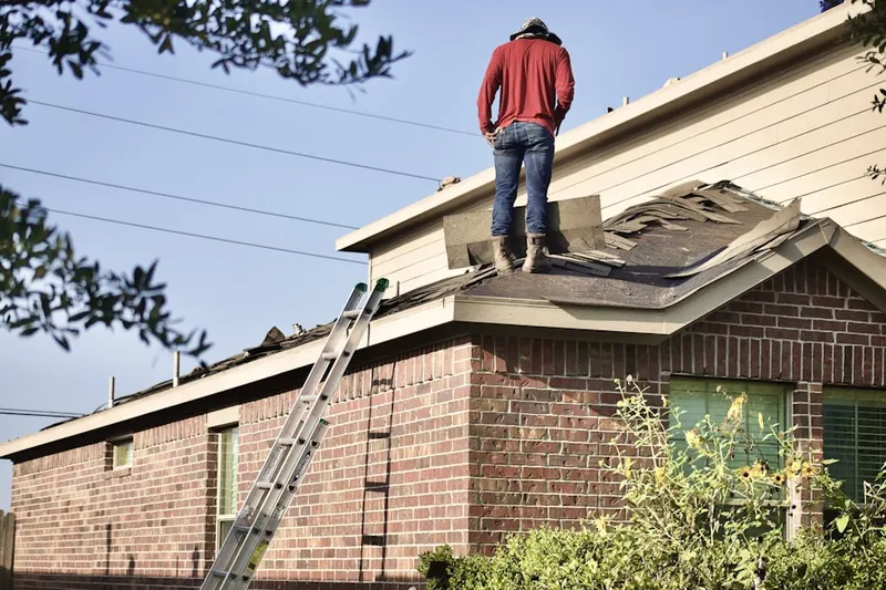 Professional roofer working on a residential roof in Krum